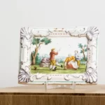 Pair of faience picture plates with peasant scenes
